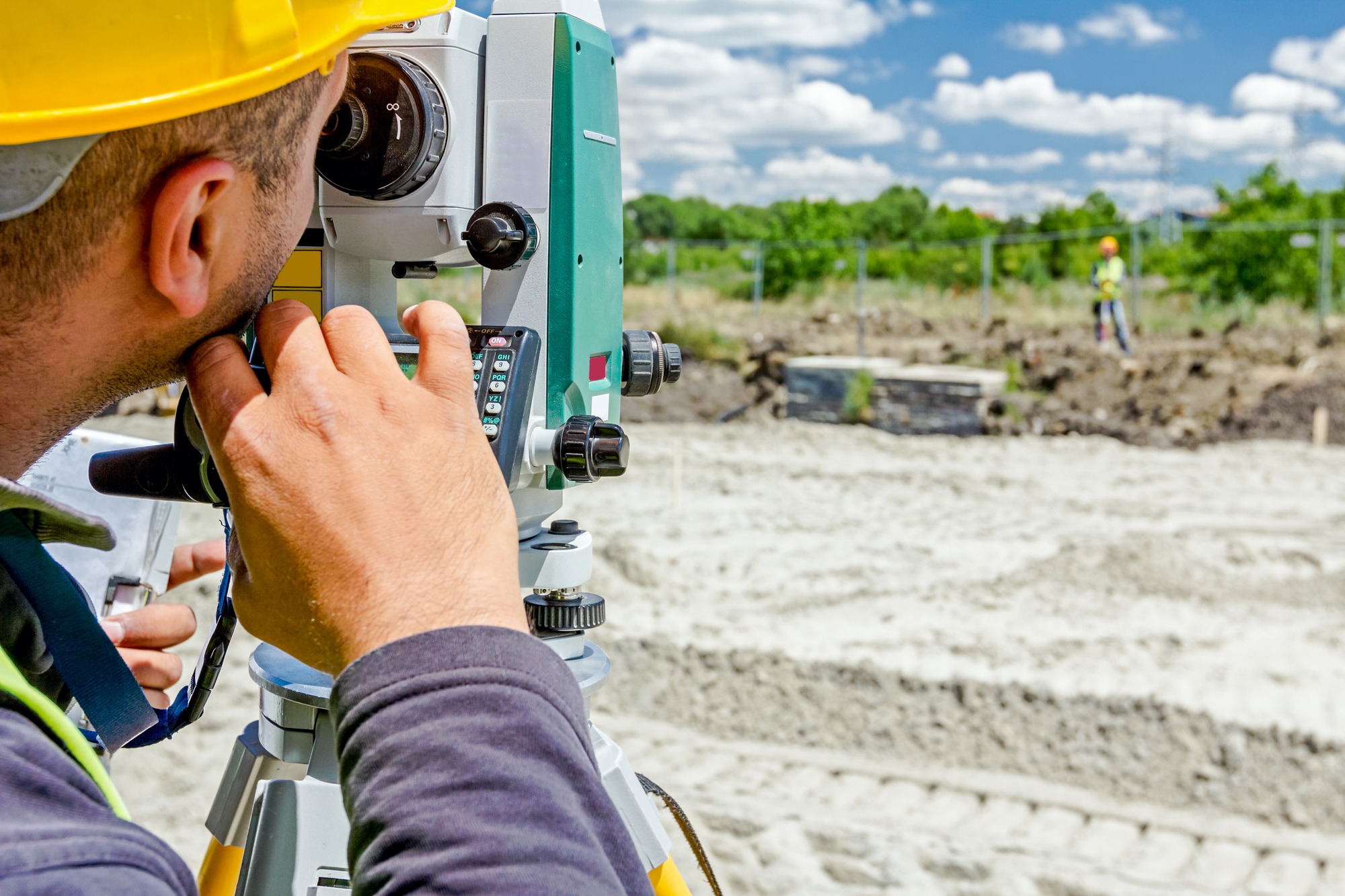 Surveyor engineer is measuring level on construction site